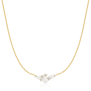 Gold necklace with pearls and small diamonds on a white background