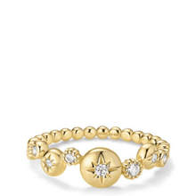 Gold ring with star and diamond design on a white background