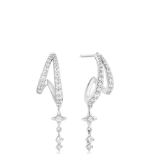 Silver hoop earrings with star-shaped drops on a white background