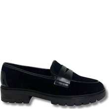 A single black slip-on loafer with a mix of matte suede and smooth leather textures, featuring a chunky lug sole and a decorative strap across the vamp, shown against a plain white background.