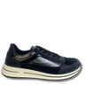 A black leather sneaker with a textured metallic iridescent side panel, black laces, and a thick cream-colored sole, shown from a side profile on a white background.