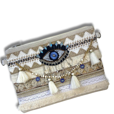 Decorative clutch bag with eye design and tassels on a white background