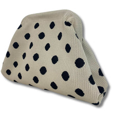 Beige cushion with black polka dots on a white background