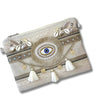 Decorative clutch bag with eye design, tassels, and embellishments on a white background