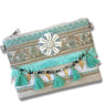 Decorative pouch with tassels and embellishments on a white background