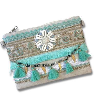 Decorative pouch with tassels and embellishments on a white background