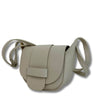 Beige leather handbag with a strap on a white background
