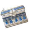 Decorative pouch with blue tassels and shell embellishments on a white background