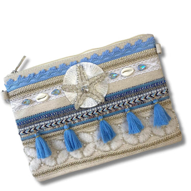 Decorative pouch with blue tassels and shell embellishments on a white background