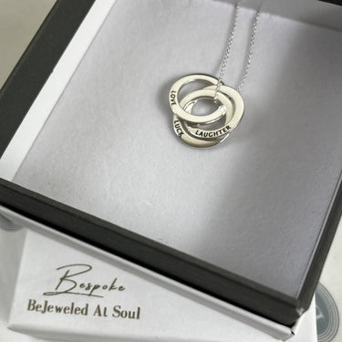 Silver necklace with interlocking rings in a 'Bespoke Bejeweled At Soul' box.