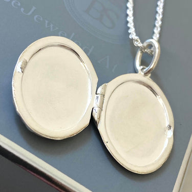 Silver locket on a chain with a blurred background