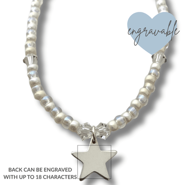 Bracelet with star charm and engraved heart tag on a white background
