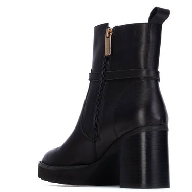 Black platform boot with a gold zipper on a white background