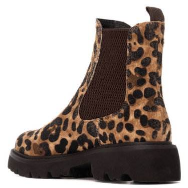 Leopard print boot with a brown sole on a white background