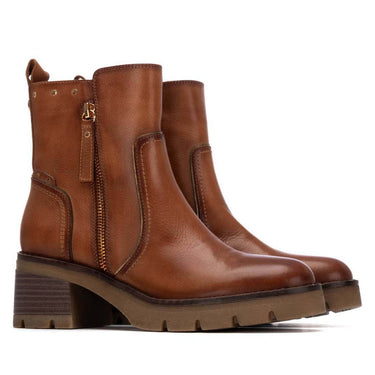 Pair of brown leather boots on a white background