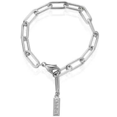 Silver chain bracelet with a tag on a white background
