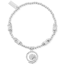 Silver bracelet with a heart charm on a white background