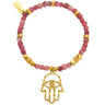 Bracelet with pink beads and gold Hamsa hand charm on a white background