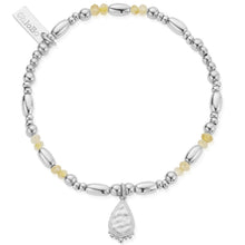 Silver bracelet with beads and a teardrop charm on a white background