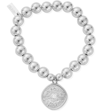 Silver beaded bracelet with a round, textured charm on a white background