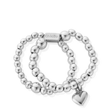 Silver beaded bracelet with a heart charm on a white background