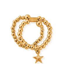 Gold beaded bracelet with a star charm on a white background