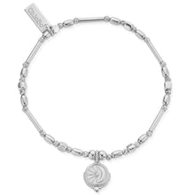 Silver bracelet with a decorative charm on a white background