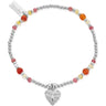 Bracelet with colorful beads and a heart charm on a white background