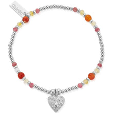 Bracelet with colorful beads and a heart charm on a white background