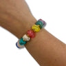 Colorful beaded bracelet on a wrist against a white background