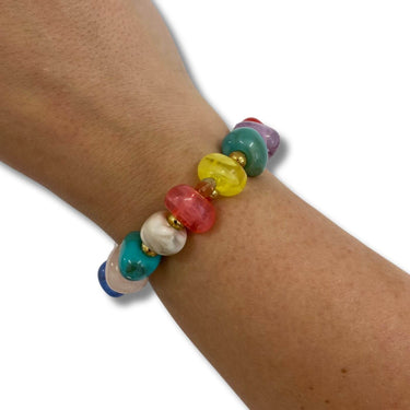 Colorful beaded bracelet on a wrist against a white background