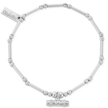 Silver bracelet with beads and a tag on a white background
