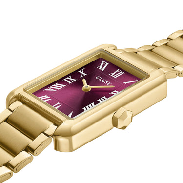 Gold watch with a purple face and 'Cluse' branding on a white background