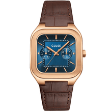 Cluse watch with brown leather strap and blue face on a white background