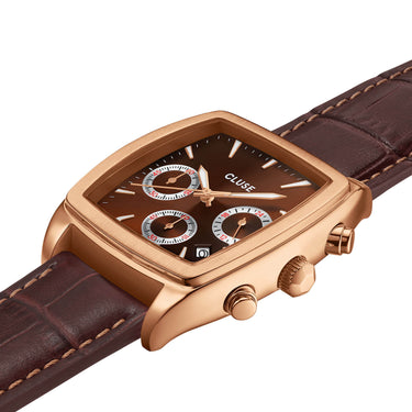Rose gold watch with brown leather strap on a white background