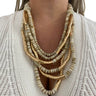 Necklace with gold and beige beads on a white background