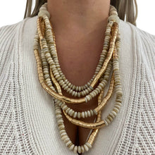 Necklace with gold and beige beads on a white background
