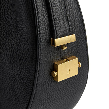 Black leather handbag with gold hardware on a white background
