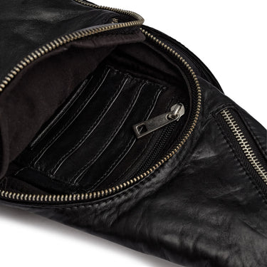 Close-up of a black leather jacket with zippers on a white background