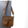 Brown leather shoulder bag on a gray background