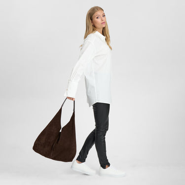 Woman holding a brown bag on a white background