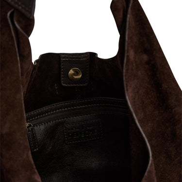 Close-up of a brown leather bag with a gold zipper pull on a white background