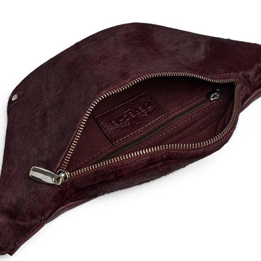 Maroon suede fanny pack with a zipper on a white background