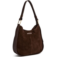 A dark brown suede hobo shoulder bag with dark brown leather trim and gold-tone hardware, featuring a small silver-tone brand plaque on the front.