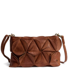 A brown leather shoulder bag with a distinctive 3D geometric petal design on the front flap, featuring a matching adjustable shoulder strap and gold-tone hardware, shown against a plain white background.