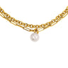 A gold-toned layered necklace featuring a textured chain, a paperclip chain, and a single dangling white pearl, shown against a plain white background.
