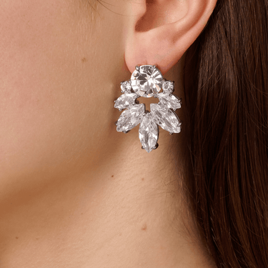 Close-up of a woman wearing a sparkling silver earring.