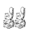 A pair of silver-toned drop earrings with large clear faceted gemstones, shown on a plain white background.
