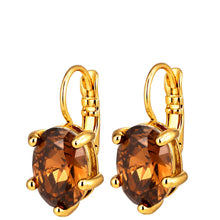 A pair of gold leverback earrings with large oval faceted brown gemstones, shown on a plain white background.