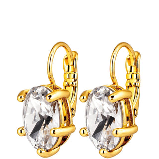 A pair of gold leverback earrings with large, clear oval-cut crystals in a prong setting, shown against a plain white background.